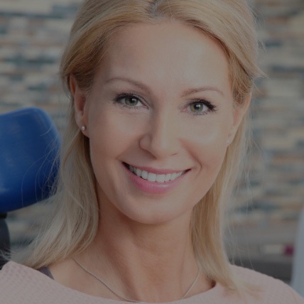 A Beautiful Lady Sitting On A Dental Chair