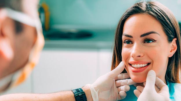 Male Dentist Examing Teeth Of Female Patient
