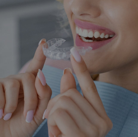 Girl With Beautiful Smile Holding A Transparent Mouthguard.