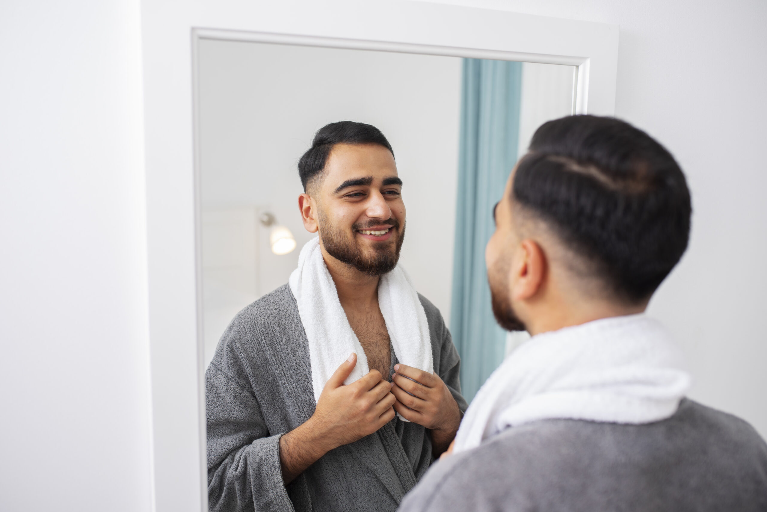 close-up-smiley-man-looking-mirror