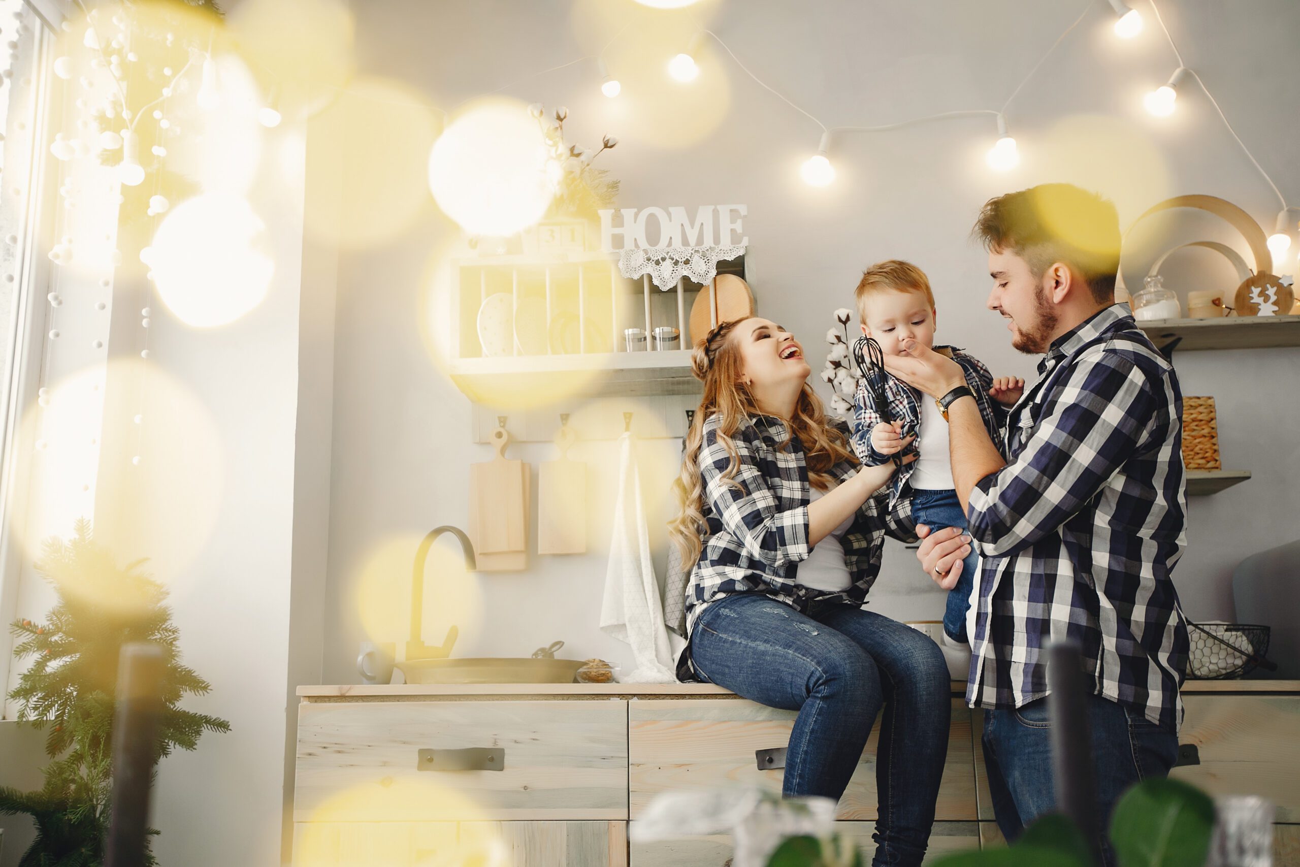 Family on the kitchen. Blonde in a blue shirt. Pregnant woman with her husband and little son
