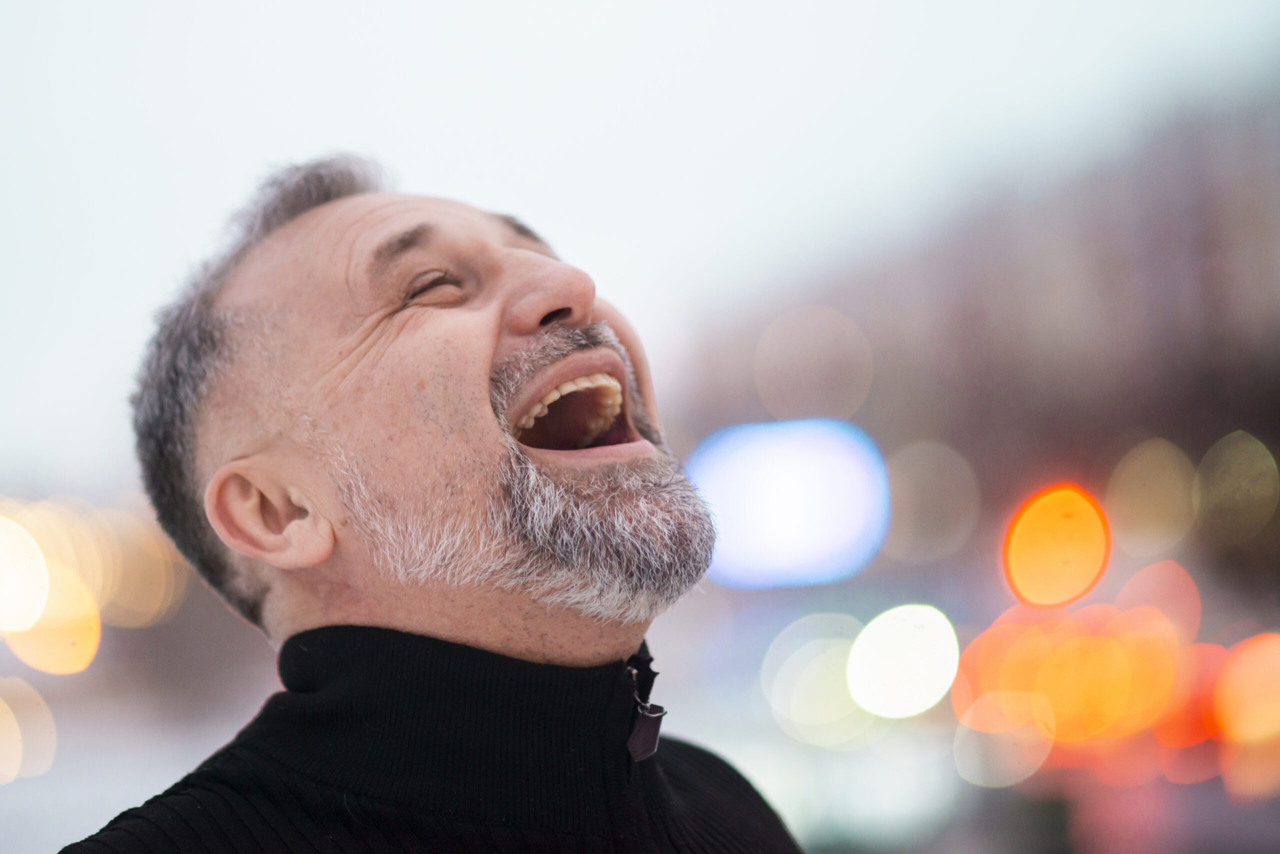 mature-man-laughing-outside-close-up