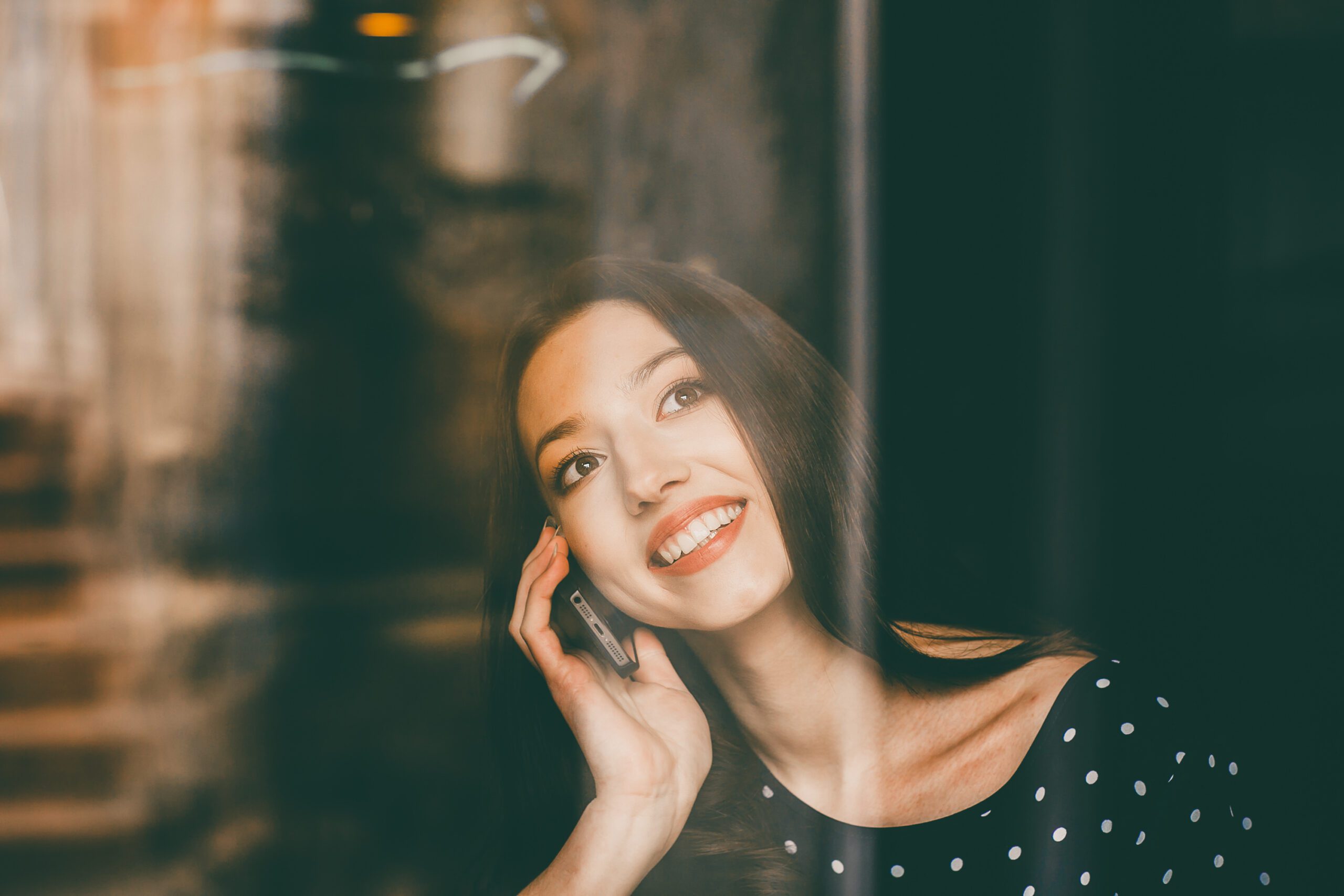 Beautiful girl works with technologise on the phone and smiles